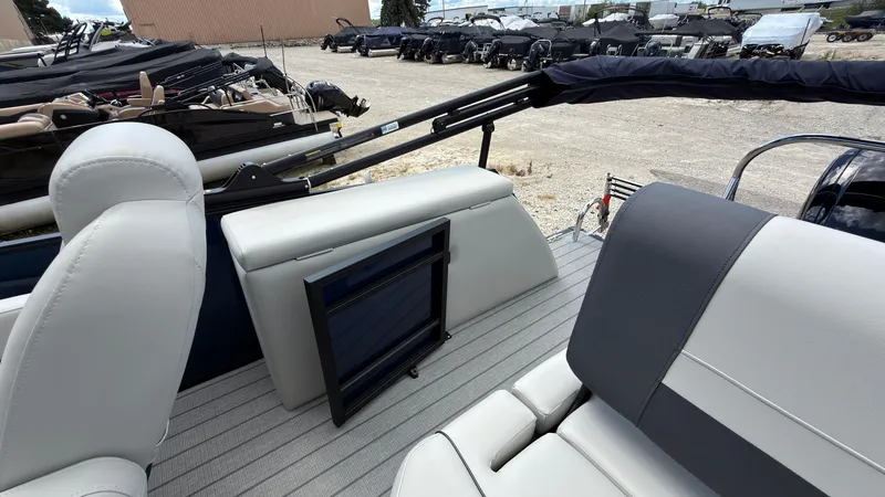Slide: The Image of The image shows the deck of a Starcraft EX 20 Q DH boat with gray and white seating. - 45