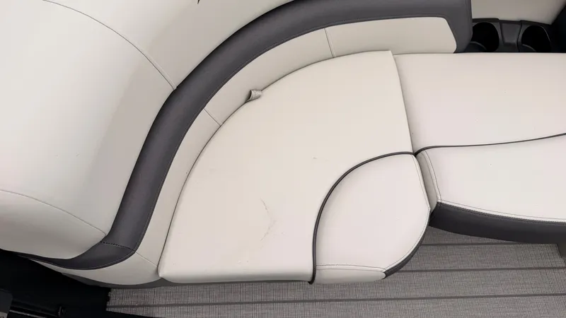 Slide: The Image of The image shows a white cushioned seat with gray accents on a boat. - 18