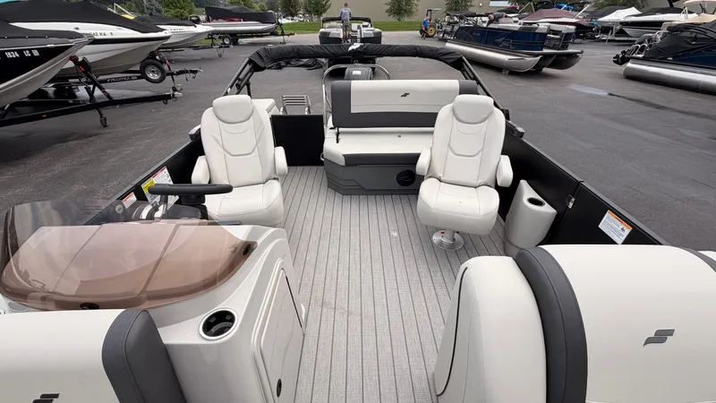Slide: The Image of The image shows a 2027 Starcraft EX 20 Q DH pontoon boat with luxurious seating and gray flooring. - 22