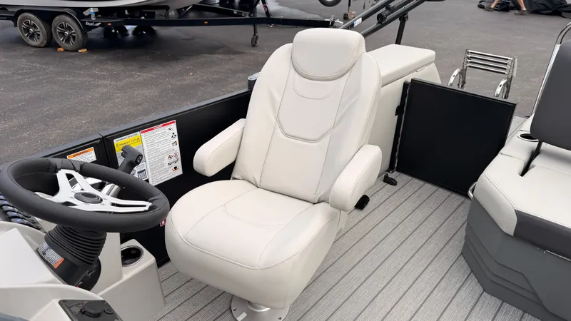 Slide: The Image of The 2027 Starcraft EX 20 Q DH features a sleek, cushioned captain's chair and a modern steering wheel. - 32