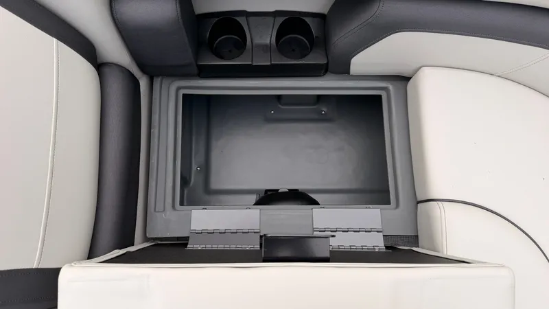 Slide: The Image of An open storage compartment with two cup holders in a boat. - 15