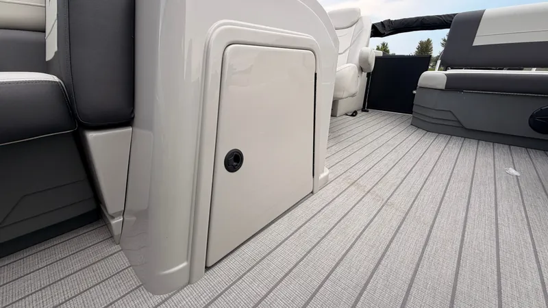Slide: The Image of The image shows the interior of a Starcraft EX 20 Q DH boat with gray flooring. - 23