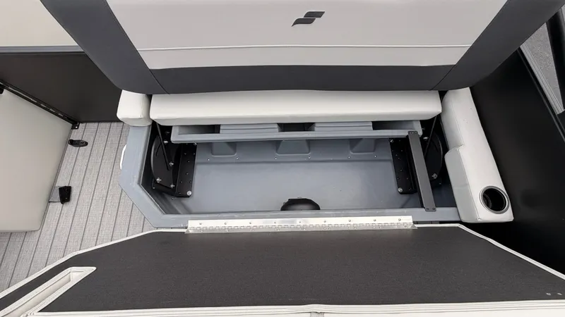Slide: The Image of The image shows the storage area of a 2027 Starcraft EX 20 Q DH boat with gray upholstery. - 42