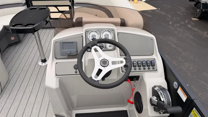 Slide: The Image of The image shows the helm of a Starcraft EX 20 Q DH boat with a modern steering wheel and instruments. - 33