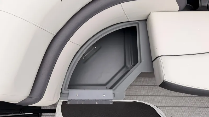 Slide: The Image of The image shows a seating area with gray storage underneath on a Starcraft boat. - 19