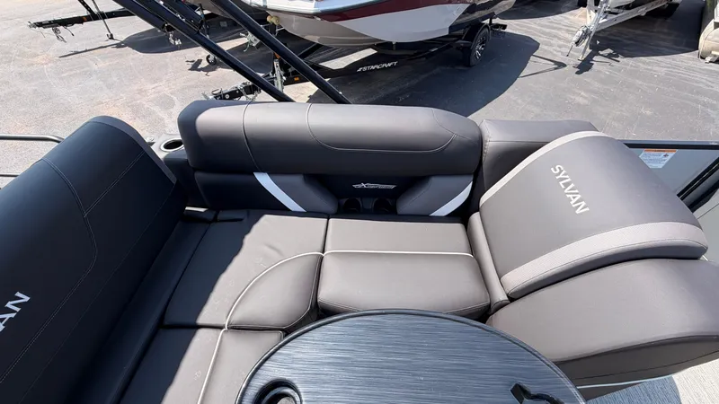 Slide: The Image of 2026 Sylvan MIRAGE X3 DLZ BAR with sleek, cushioned seating and a round table. - 44