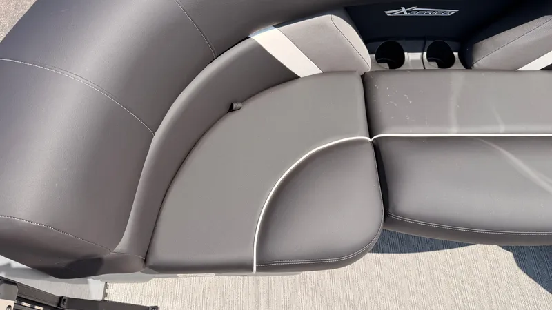 Slide: The Image of The 2026 Sylvan MIRAGE X3 DLZ BAR features sleek, cushioned seating with cup holders. - 17