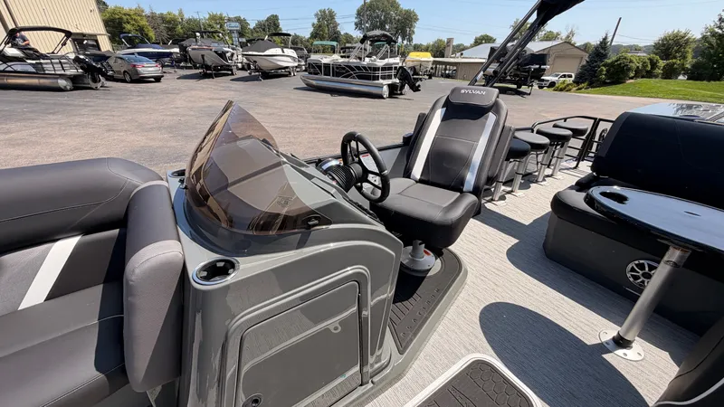 Slide: The Image of The image shows a modern pontoon boat with gray seating and a sleek helm station. - 29