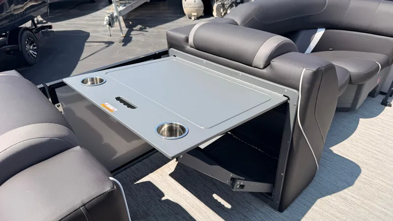 Slide: The Image of A modern pontoon boat with a fold-out table and cup holders on the deck. - 28