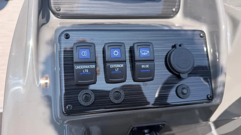 Slide: The Image of Close-up of a boat control panel with switches for underwater lights, exterior lights, and bilge pump. - 32