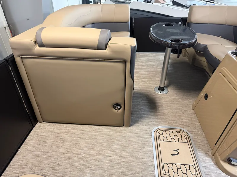 Slide: The Image of Interior of a 2026 Sylvan MIRAGE X1 CLZ DH with beige upholstery and a round table. - 13