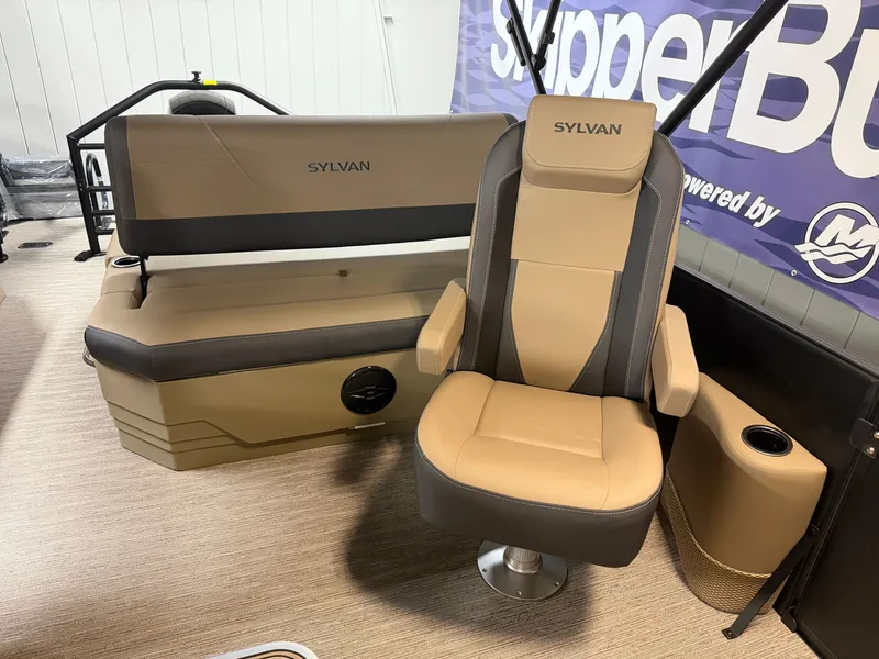 Slide: The Image of Interior of a 2026 Sylvan MIRAGE X1 CLZ DH with beige and gray seating area. - 12