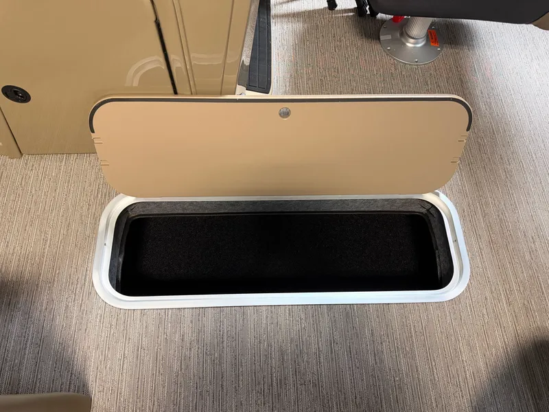 Slide: The Image of An open storage compartment in the carpeted floor of a boat. - 10