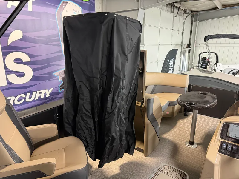 Slide: The Image of The image shows the interior of a 2026 Sylvan MIRAGE X1 CLZ DH boat with beige seating. - 14
