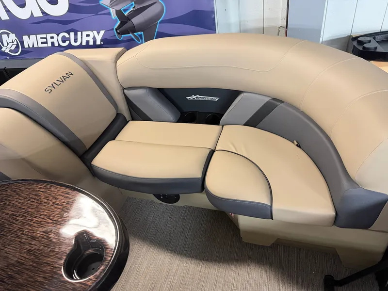 Slide: The Image of The image shows a beige and gray seating area in a Sylvan boat, model MIRAGE X1 CLZ DH. - 5