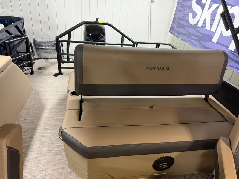 Slide: The Image of The image shows the interior of a 2026 Sylvan MIRAGE X1 CLZ DH boat with beige seating. - 18