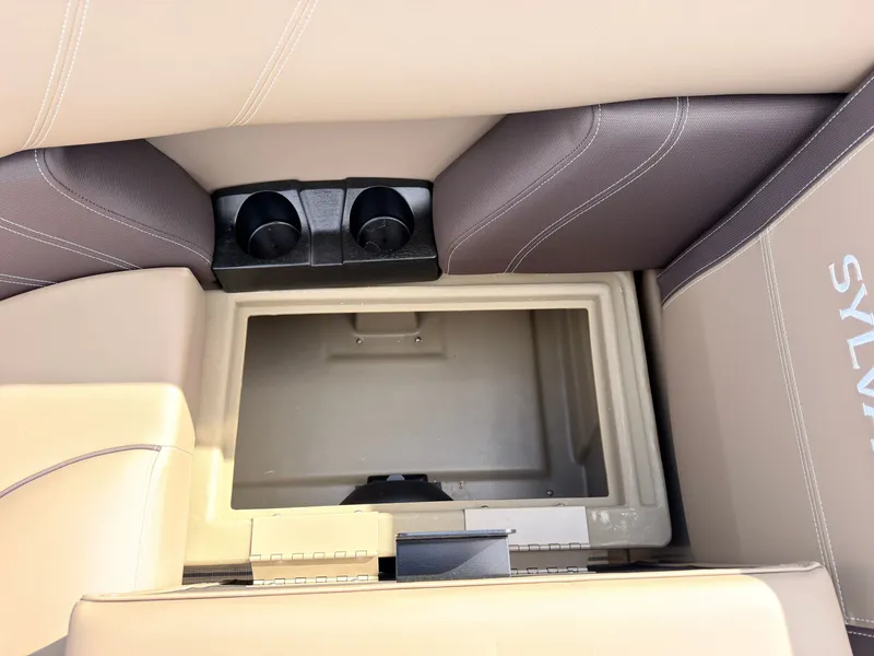 Slide: The Image of Interior view of a 2027 Sylvan Mirage 8520 CLZ DH with storage compartment and cup holders. - 25