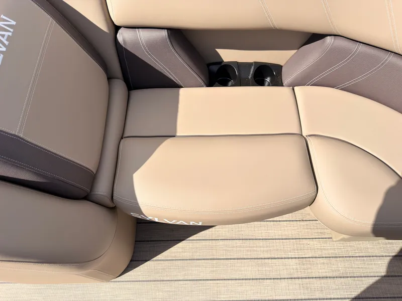 Slide: The Image of Beige upholstered seats on a boat with built-in cup holders. - 15