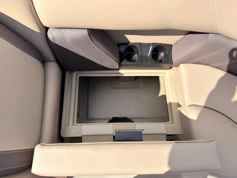 Slide: The Image of Interior view of a 2027 Sylvan Mirage 8520 CLZ DH with storage compartment and cup holders. - 16