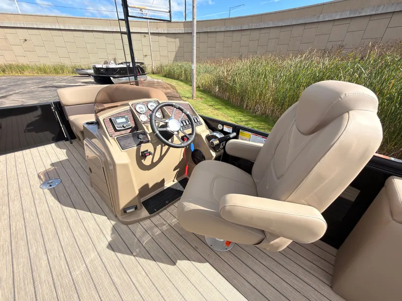 Slide: The Image of The image shows the cockpit of a 2027 Sylvan Mirage 8520 CLZ DH with a beige captain's chair and modern dashboard. - 38