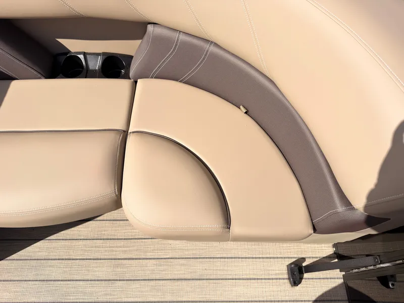Slide: The Image of Close-up of a beige boat seat with brown accents and cup holders. - 13