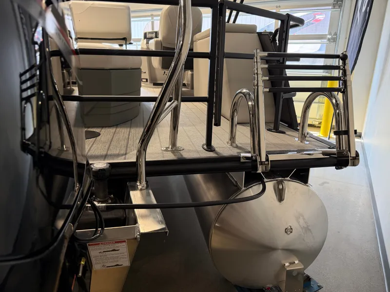 Slide: The Image of The image shows the rear of a Sylvan Mirage 8520 CLZ DH pontoon boat with a swim ladder. - 21
