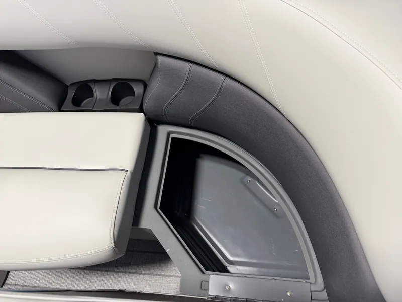 Slide: The Image of Close-up of a seating area with gray and white upholstery and cup holders. - 7