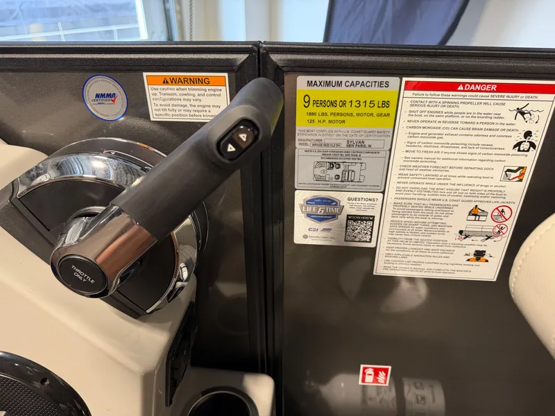 Slide: The Image of Close-up of the throttle and capacity panel of a 2027 Sylvan Mirage 8520 CLZ DH. - 13