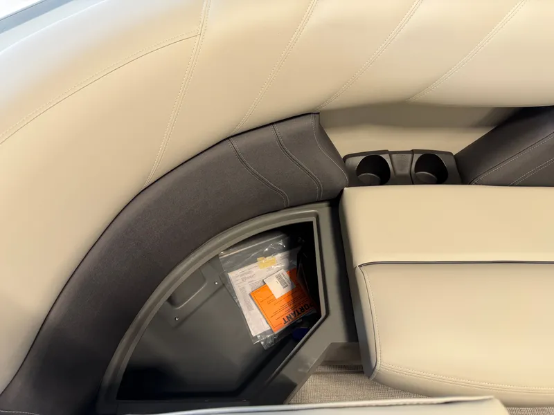 Slide: The Image of The image shows a beige and black boat seat with built-in storage and cup holders. - 5