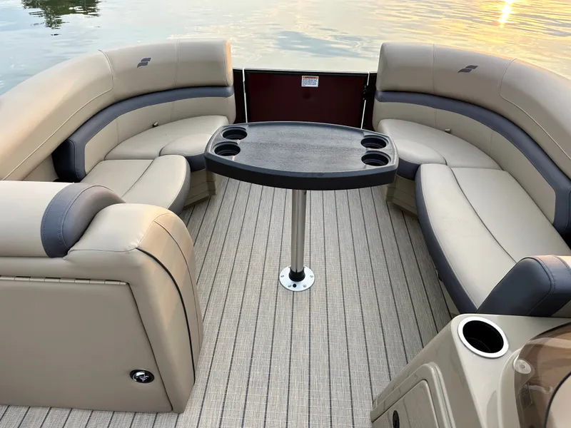 Slide: The Image of The image shows the interior of a 2026 Starcraft EXS 1 Q DH boat with beige seating. - 2