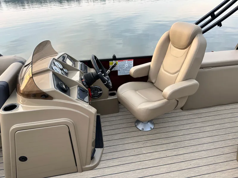 Slide: The Image of The image shows the helm of a Starcraft EXS 1 Q DH boat with a beige captain's chair. - 3