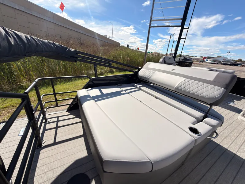 Slide: The Image of The image shows the deck of a 2027 Starcraft EXS 1 Q DH boat with cushioned seating. - 44