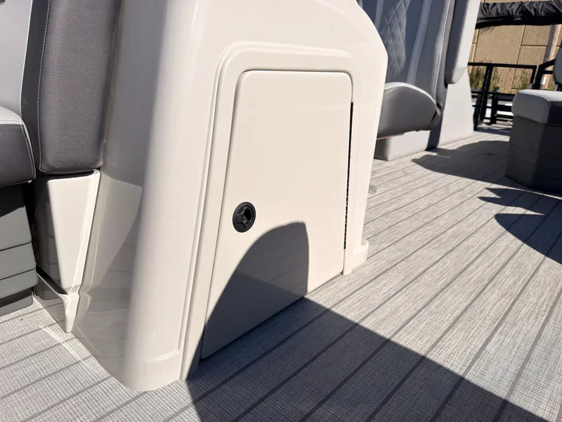 Slide: The Image of Close-up of a boat deck with gray flooring and a white door. - 20