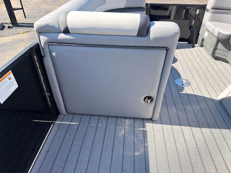 Slide: The Image of The image shows the gray upholstery of a bench seat on a boat with a wooden floor. - 25