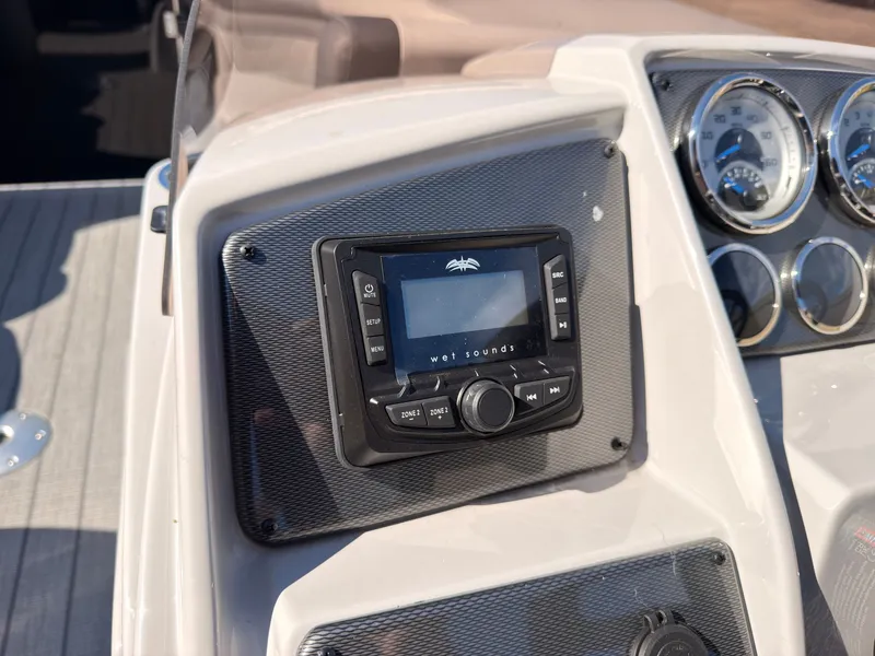 Slide: The Image of The image shows the dashboard of a Starcraft EXS 1 Q DH boat with a Wet Sounds audio system. - 32
