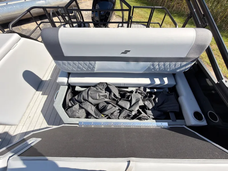 Slide: The Image of The image shows the seating area of a 2027 Starcraft EXS 1 Q DH boat with storage underneath. - 41