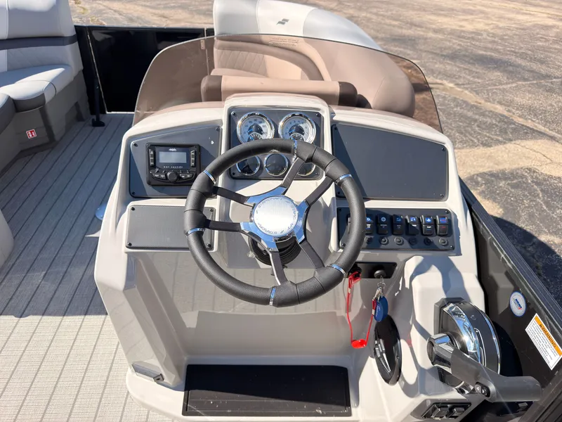 Slide: The Image of The image shows the helm of a Starcraft EXS 1 Q DH boat with a steering wheel and instruments. - 31
