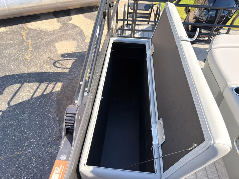 Slide: The Image of An open storage compartment on a 2027 Starcraft EXS 1 Q DH boat. - 43