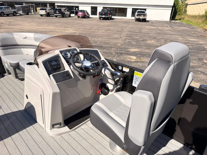 Slide: The Image of The image shows the cockpit of a 2027 Starcraft EXS 1 Q DH boat with gray seats. - 30