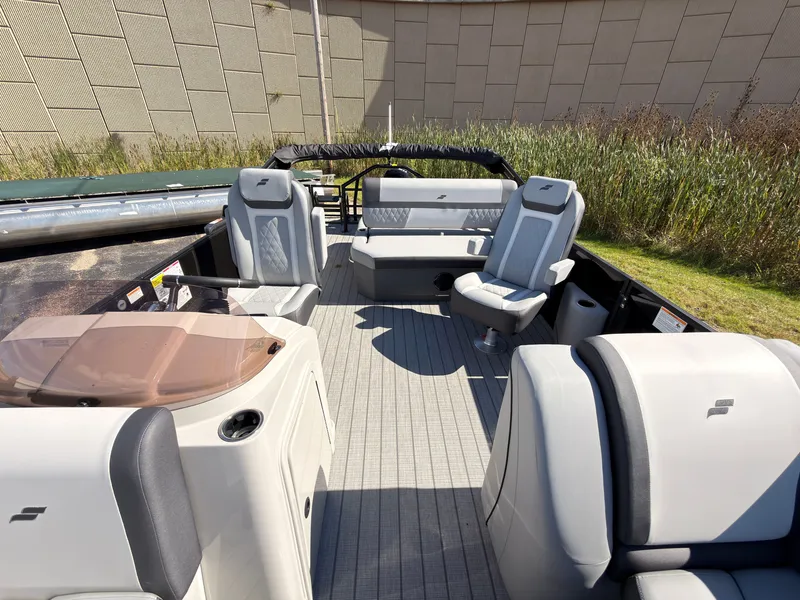 Slide: The Image of The image shows the spacious deck of a Starcraft EXS 1 Q DH boat with sleek seating. - 19