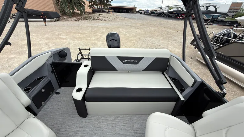 Slide: The Image of The image shows the rear of a Starcraft VX 20 Q DH boat with gray and black seating. - 42