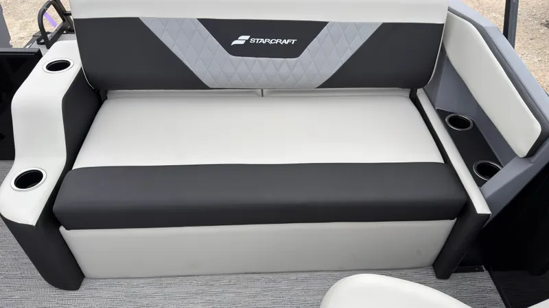 Slide: The Image of The 2027 Starcraft VX 20 Q DH features a black and white bench seat with cup holders. - 43