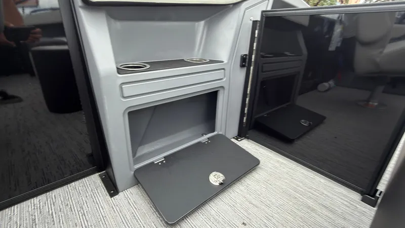 Slide: The Image of Interior of a Starcraft VX 20 Q DH with storage compartment and cup holders. - 47