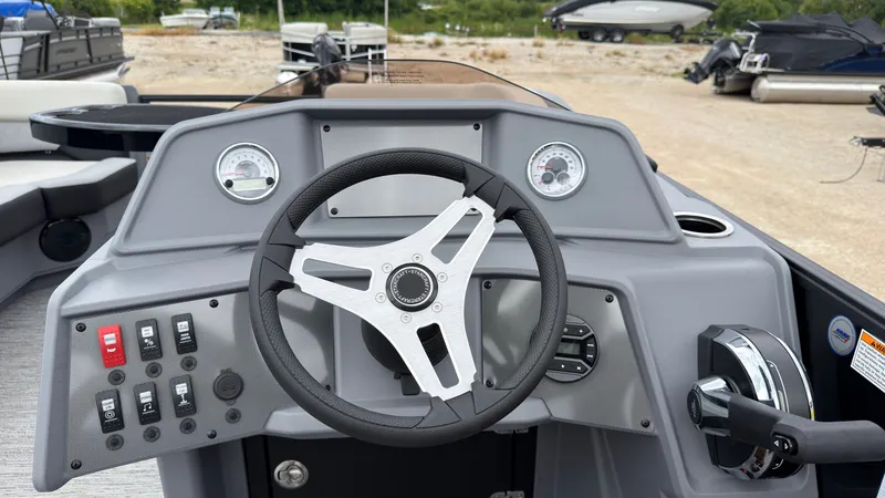 Slide: The Image of The image shows the helm of a 2027 Starcraft VX 20 Q DH with a modern steering wheel and gauges. - 33