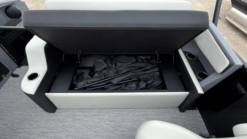 Slide: The Image of The 2027 Starcraft VX 20 Q DH features an open storage compartment under a bench seat with black fabric. - 44