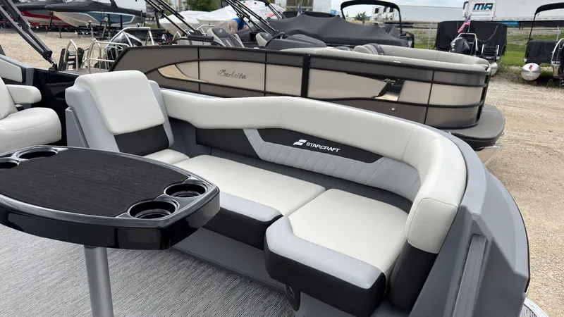 Slide: The Image of The image shows the sleek seating area of a 2027 Starcraft VX 20 Q DH with gray and white upholstery. - 16
