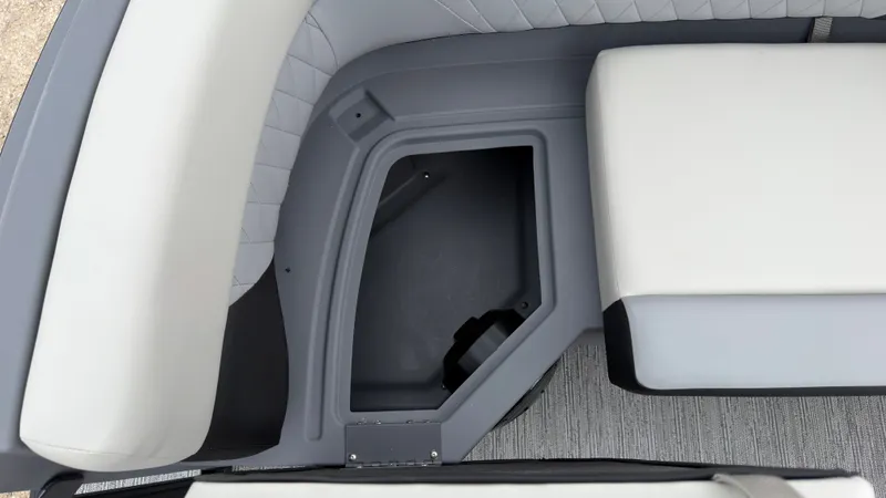 Slide: The Image of The image shows a gray and white seat with an open storage compartment. - 18
