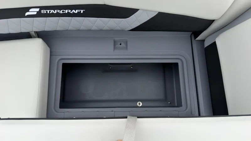 Slide: The Image of A gray storage compartment on a Starcraft boat with cushioned seats and diamond pattern. - 20