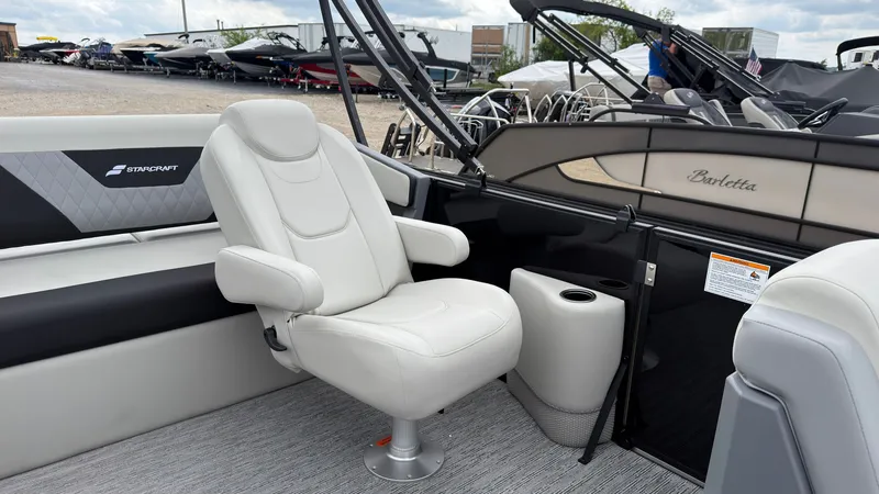 Slide: The Image of A modern seat on a Starcraft VX 20 Q DH boat, surrounded by other boats in the background. - 29