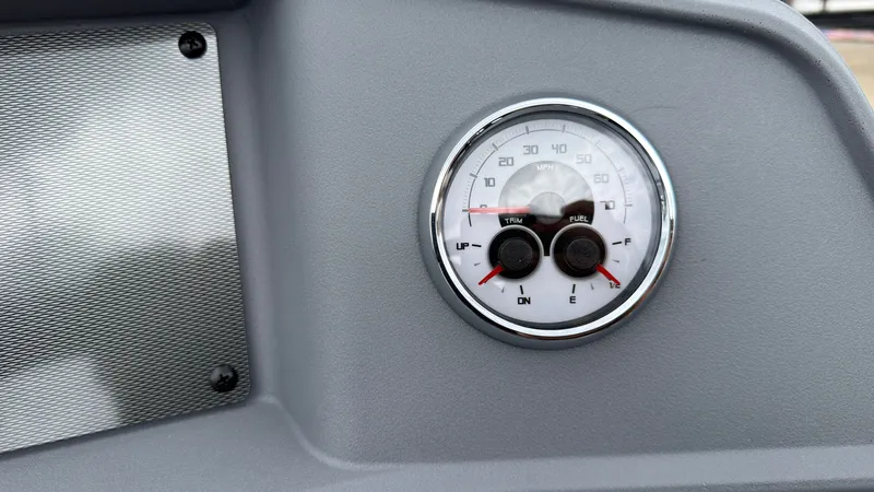 Slide: The Image of Close-up of a boat instrument with fuel and trim gauges on a gray dashboard. - 36